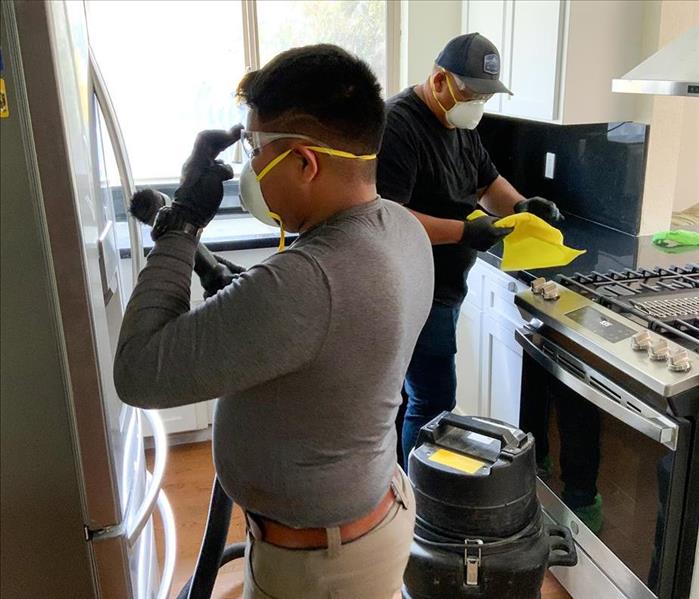 SERVPRO team cleaning a kitchen